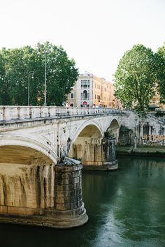 an old bridge over a river in the city