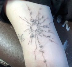 a person with a tattoo on their arm that has many small flowers growing out of it