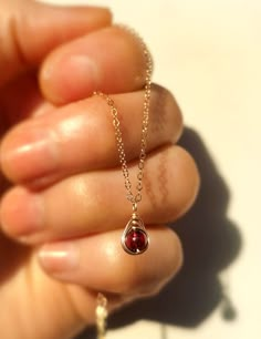 Petite, dainty and delicate. This Tiny Garnet Pendant Necklace is perfect for those who like discreet jewelry and minimalist fans. The pendant is delicately handmade with a wire-wrapping technique on a 4mm garnet gemstone bead.• Pendant size: 1 x 0.5 cm• Please note that the images are zoomed in for details and the items may appear larger in photographs. Kindly take note of the dimension provided.• All metal parts are 14k gold filled, rose gold filled, or sterling silver.• Garnet used is a natur Garnet Necklace Silver, Cute Pendants, Wire Wrapping Techniques, Mini Collection, Dainty Pendant, Garnet Pendant, Garnet Necklace, Bead Pendant, Garnet Jewelry