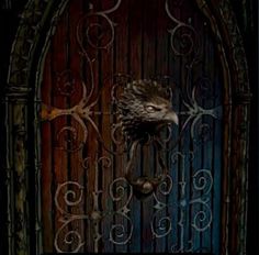 an iron gate with a bird head on it