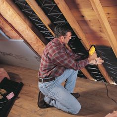 a man is working on the ceiling in his house with an air blower attached to it