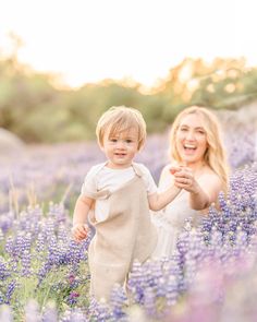 a mother and her toddler playing in a lavender field