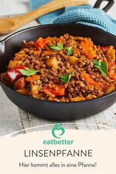 a pan filled with meat and vegetables on top of a table