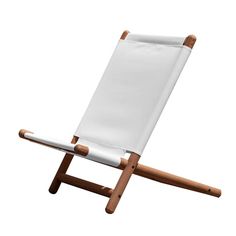 a white chair with wooden legs on a white background in front of a white backdrop