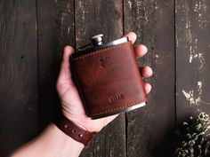 a person holding a flask in their hand