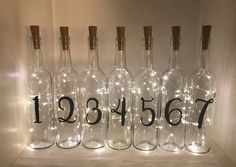 there are bottles with numbers on them and some lights in the bottom one is empty