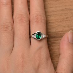 It is a lab emerald ring. The main stone is 6 mm*8 mm oval cut.weight about 1.13 carats. The basic metal is sterling silver and plated with rhodium. To change the metal to a solid gold (white/rose) or platinum is also available, please ask for a quotation if you want. You can also go to my shop Home for more elegant rings: https://www.etsy.com/shop/godjewelry?ref=hdr_shop_menu Emerald is the May birthstone More emerald rings: https://www.etsy.com/shop/godjewelry?section_id=20709240 Customization Green Oval Sterling Silver Birthstone Ring, Oval Emerald Promise Ring, Oval Emerald May Birthstone Ring, Oval Emerald Birthstone Ring With Halo Setting, Oval Emerald Birthstone Ring For May, Oval Sterling Silver Emerald Promise Ring, Oval Emerald Sterling Silver Promise Ring, Oval Emerald Promise Ring In Sterling Silver, Oval Emerald Birthstone Ring In Silver