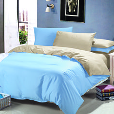 a bed with blue sheets and pillows in a room next to a painting on the wall