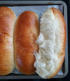 two long loafs of bread sitting on top of a pan