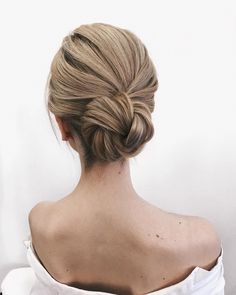 a woman with blonde hair in a low bun