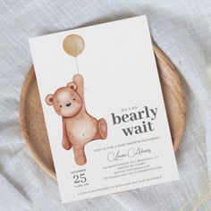 a card with a bear holding a balloon on it's back and the words, we can bearly wait