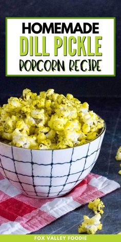 homemade dill pickle popcorn recipe in a white bowl on a red and white checkered napkin