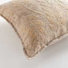 a close up of a decorative pillow on a white surface with no one around it