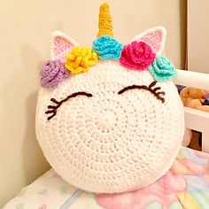 a crocheted unicorn pillow sitting on top of a bed with the words pattern digital downloaded