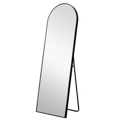 a mirror that is standing up against a white wall and has a black frame on it