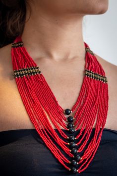 "Beautifull red layered necklace that is a true eye catcher. These nepalese traditional craftmanship necklaces (Mala) are made with a modern touch. A \"pote\" is a traditional nepali necklace made by stringing small cut (glass) beads. This necklace is designed in a trending long style and is durable and skin friendly." Red Fair Trade Jewelry With Round Beads, Red Fair Trade Necklace As Gift, Fair Trade Red Jewelry For Festivals, Red Fair Trade Jewelry For Festivals, Fair Trade Jewelry For Festivals, Festive Fair Trade Jewelry For Festivals, Red Adjustable Temple Jewelry Necklace, Unique Red Fair Trade Necklace, Artisan Red Fair Trade Necklace