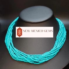 This is a southwest glass seed bead multi-strand necklace. These beads are turquoise.  Dress up your outfit with a minimalist traditional mixed hand- beaded necklace. This is the shorter versions, we also have the longer versions.  * 10 strands of turquoise colored glass seed beads * 18" long * hand beaded in New Mexico * hook and eye clasp with extender * adjustable -Gift boxes available for purchase shown in photos. -Also comes in a nice presentation box. Check out the rest of our collection: https://www.etsy.com/shop/NewMexicoGems Turquoise Multi-strand Beaded Necklaces With Tiny Beads, Turquoise Multi-strand Tiny Beads Necklace, Turquoise Multi-strand Beaded Necklaces, Southwestern Multi-strand Turquoise Beads, Turquoise Multi-strand Jewelry With Tiny Beads, Turquoise Multi-strand Tiny Beads, Southwestern Multi-strand Beads, Hand Beaded Necklace, Turquoise Dress