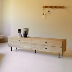 a wooden cabinet with two coffee mugs on it