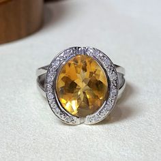 Vintage Natural Citrine & Diamond Halo 14K White Gold Ring....Marked 14K...Total of weights 4.8grams... Size 5...Measure of stone center 12 x 9MM...Measure of Face 15MM...It's in very good condition. Oval Yellow Gold Gemstones With Halo Setting, Fine Jewelry Oval Topaz Gemstones, Oval Topaz Ring With Citrine Accents, Oval Yellow Gold Topaz Gemstones, Oval Citrine Topaz Ring In White Gold, Yellow Oval Topaz Ring With Accent Stones, Oval Yellow Topaz Ring With Accent Stones, Yellow Oval Topaz Ring With Halo Setting, Fine Jewelry Citrine Gemstone Ring