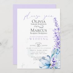 a wedding card with purple flowers and blue watercolors on the front is shown