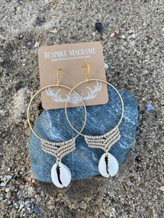 "Handcrafted micro macrame on a 2\" brass hoop with a puka shell charm. These boho beach vibe earrings will instantly transport you to vacation mode. Each shell is unique but I will careful select two that are as close to a pair as possible. Custom color cord options considered. Please DM your request." Handmade Small Hoop Earrings For Vacation, Handmade Small Hoop Jewelry For Vacation, Handmade Hoop Jewelry For The Beach, Handmade Hoop Jewelry For Vacation, Natural Color Dangle Jewelry For Beach, Natural Dangle Jewelry For Beach, Bohemian Small Hoop Earrings For Beach, Bohemian Small Hoop Earrings For Vacation, Adjustable Small Hoop Jewelry For Beach