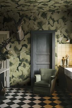 a room with black and white checkered flooring and wallpaper that has flowers on it