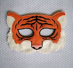 an orange and white tiger mask with big eyes