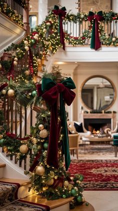 christmas decorations on the banisters and stairs in a house with red, green and gold ornaments