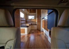 the inside of a camper with wood flooring