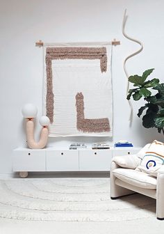 a living room filled with furniture and a painting on the wall