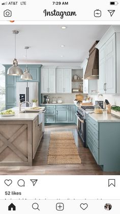 a large kitchen with blue cabinets and wooden floors is pictured in this image from the front view