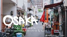 an alley way with people walking down it and the words osak above them in white