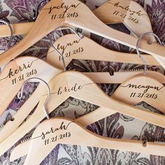 wooden hangers with names and date on them for brides, grooms, and guests