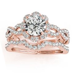 a rose gold wedding ring set with an intricate design and round brilliant cut diamond in the center