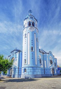 a blue and white building with a cross on the top