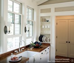 the kitchen is clean and ready to be used for cooking or baking, as well as dishes on the counter