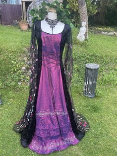 "🕷FREE CHOKER 🕷  WITH THIS PURCHASE  THIS STUNNING ENCHANTED ORIGINAL HAND CRAFTED DRESS HAS BEEN  FASHIONED  IN THE PRINCESS LINE STYLE  IT IS MADE FROM IN A LUXURIOUS TRULY GORGEOUS MIDNIGHT BLACK CRUSHED VELVET  (CONTAINING LYCRA) ...    IDEAL FOR  A  MEDIEVAL / RENAISSANCE THEMED BALL, PARTIES, SAMHAIN / HALLOWEEN 🎃 , HANDFASTINGS / WEDDINGS, OR ANY SPECIAL, SACRED OCCASION, FOR THAT EXTRA WOW FACTOR   THE  FLOOR LENGHT MEDIEVAL CAPE STYLE SLEEVES HAVE BEEN FASHIONED FROM A STUNNING  BREA Gothic Ball Gown For Halloween, Bohemian Halloween Costume Dress, Gothic Victorian Dress For Larp At Halloween, Gothic Dresses For Medieval Festivals, Bohemian Halloween Cosplay Dress, Gothic Floor-length Dress For Medieval Festivals, Fantasy Victorian Dress For Medieval Festivals, Bohemian Dresses For Medieval Festival Costume Party, Bohemian Halloween Festival Dresses