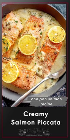 salmon with creamy sauce and lemons in a pan