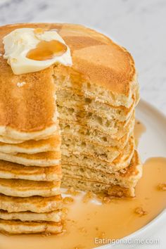 a stack of pancakes with butter and syrup on top