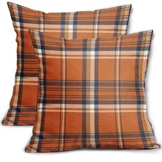 two orange plaid pillows sitting next to each other