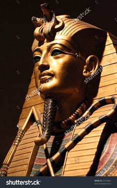 an egyptian statue in front of a building