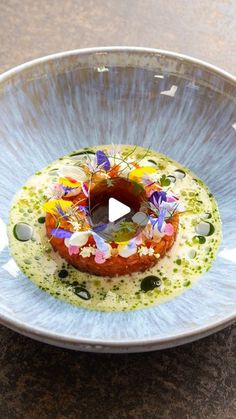 a plate with food on it and a video player in the middle showing how to make an appetizer