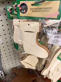 some white and brown wooden shoes are on the shelf in front of other woodworking supplies