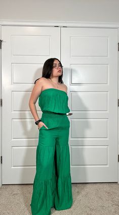 This stylish jumpsuit features a wide leg ruffle tiered design and two side pockets. Crafted from a high-quality fabric blend, it is sure to be an eye-catching addition to your wardrobe. 80% Rayon 20% Nylon Wide Leg Jumpsuits And Rompers With Pockets For Vacation, Casual Strapless Sleeveless Jumpsuit With Elastic Waistband, Casual Strapless Jumpsuit With Elastic Waistband, Spring Strapless Wide Leg Jumpsuit, Summer Solid Color Wide-leg Jumpsuits And Rompers, Solid Color Summer Jumpsuits With Wide-leg Pants, Solid Color Summer Jumpsuits And Rompers With Wide-leg Pants, Summer Wide-leg Jumpsuits And Rompers In Solid Color, Casual Strapless Jumpsuits And Rompers