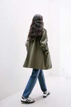 a woman is walking in the white room