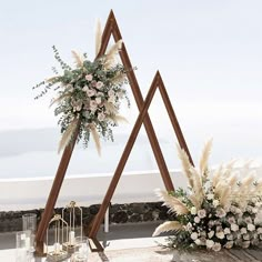 an outdoor ceremony setup with flowers and greenery