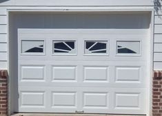 a white garage door with two windows on the side