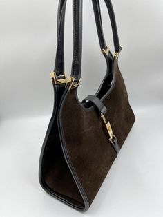 A stunning vintage Gucci Jackie bag made from brown suede, black leather with gold hardware. Inside the bag is lined with a very special gold nylon lining and there is a zipped pocket for valuables. This bag is in very good vintage condition. There are some slight marks to the suede and minor wear to be seen on the gold hardware. A true collectors item, increasingly hard to find the vintage Jackie bag's with gold hardware. This bag also comes with its original Gucci dust bag. Vintage Gucci Jackie, Gucci Collection, Pretty Bags, Mode Inspo, Brown Suede, Gucci Jackie Bag, Vintage Gucci, Bag Making, Gold Hardware