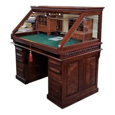 an old fashioned wooden desk with glass top