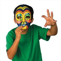 a young boy wearing a colorful mask making the peace sign